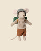 A plush toy mouse dressed in a striped shirt, brown shorts, and a light blue checkered cap carries a green backpack and features a long pink tail. It's adventure-ready with its Maileg Lantern from the Maileg Camping Set, all against a plain beige background.