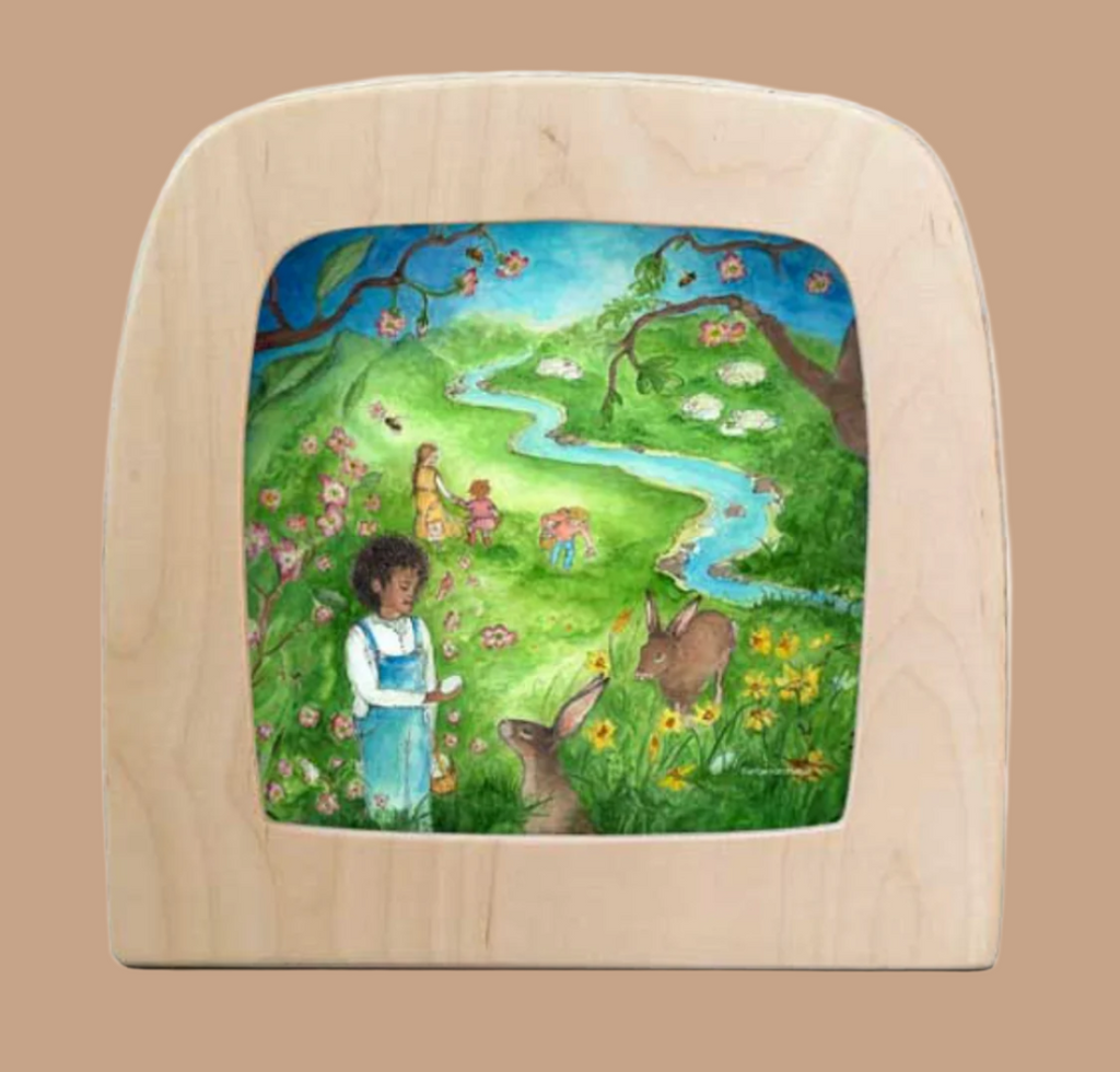 The "Silhouette Only - Spring Festivities for Toverlux Lamp" features a whimsical design of a girl with dark hair in a blue dress, rabbits in a vibrant meadow, children by a winding river, and blossoming trees and flowers.