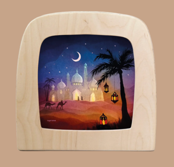 The "Silhouette Only - Oasis of Dreams for Toverlux Lamp" features a wooden frame with a desert scene at dusk, showcasing magical silhouettes: a mosque, crescent moon, palm trees, camels, and glowing lanterns against a vibrant sky transitioning from blue to orange.