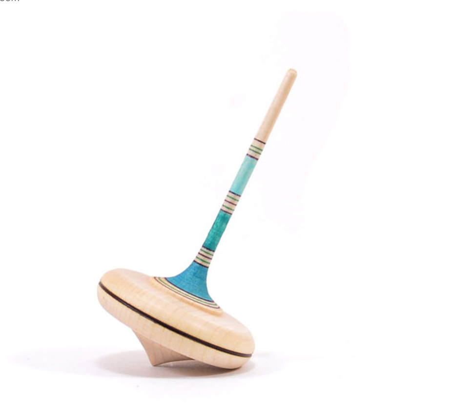 The Mader Spaghetti Spinning Top - Light Blue is a classic maple wood toy with blue and green stripes on the handle and a natural finish, balanced on its tip against a white background for safe, timeless play.