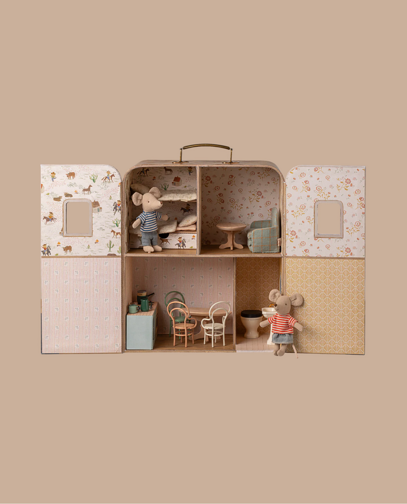 The PRE-ORDER: Maileg SuitCasa (Approx. Ship Date: Late November) is a portable miniature dollhouse with patterned walls, small furniture, a bed with soft bedding, bathtub, and two toy mice in striped clothes. All set against a beige background.
