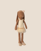 The Maileg Bunny, Size 2 in chocolate brown, wears a cream ballet suit and skirt, matching shoes, and a flower headband, standing upright against a light beige background.