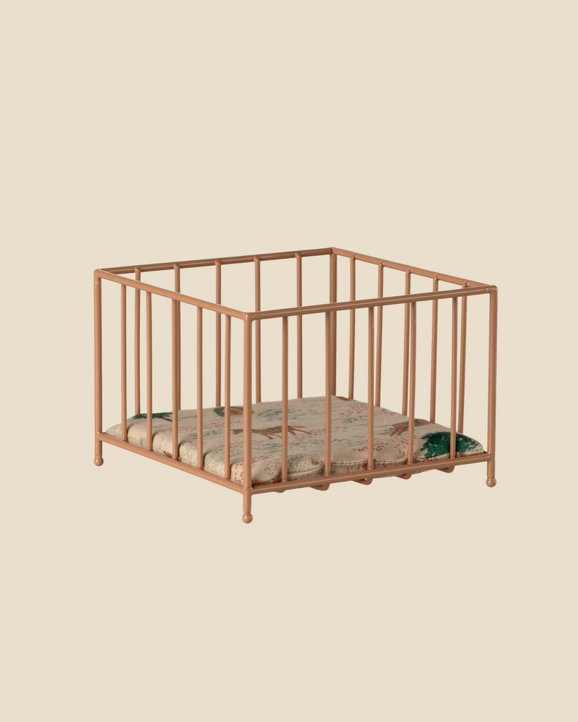 The Pre-order: Maileg Playpen, Micro - Dark powder, is a small square playpen with vertical bars and a floral cushion, shown against a plain beige background.