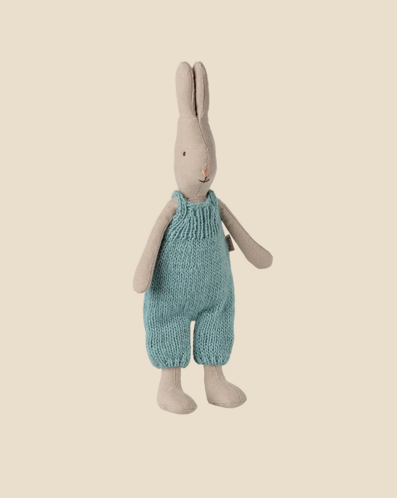 The Pre-order: Maileg Rabbit, Size 1 - Classic - Knitted Overall (arriving by 02/15/26) features a beige fabric rabbit in blue overalls, standing upright—ideal for dollhouses or fans of natural fabrics.