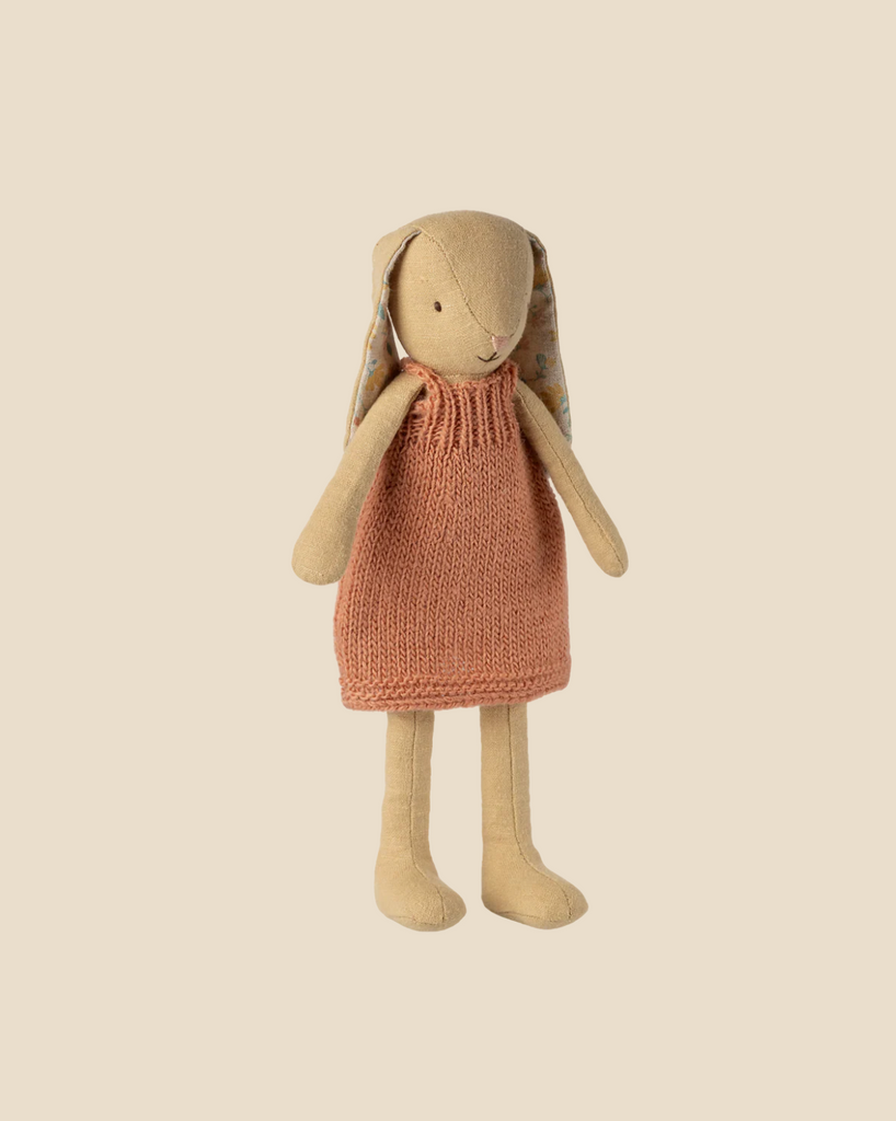 Pre-order the Maileg Bunny, Size 2, in cream yellow with a knitted dress (arriving by 02/15/26). This soft fabric bunny has long ears lined with floral fabric and stands upright against a light beige background.