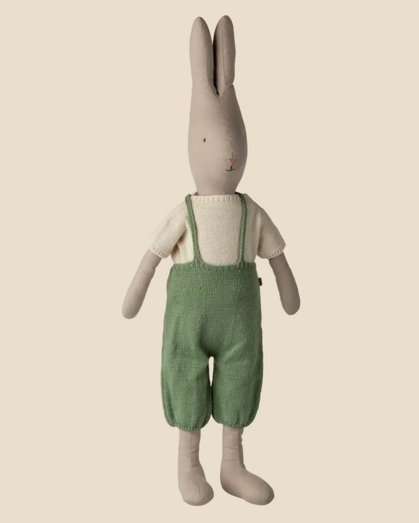 The Pre-order: Maileg Rabbit, Size 5 - Classic, wears a cream shirt and green knitted overall, standing upright against a plain beige background. Expected arrival: 02/15/26.