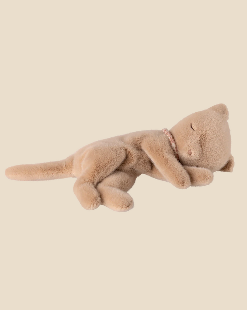 The Maileg Small Sleeping Kitten in Cozy Bed lies on its back, looking snug and ready to curl up in comfort.