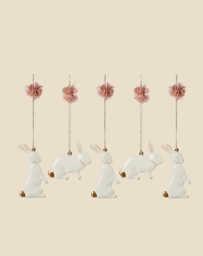 Pre-order the Maileg Metal Ornament Set - Easter Bunny, arriving 02/15/26. This set features five white bunnies with brown tails, twine loops, and pink flower accents—perfect hand-painted decor for your Easter display.