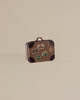 The Maileg Road Trip Adventure Set, a small vintage-style suitcase with brown corners and travel stickers, is set against a plain beige background.