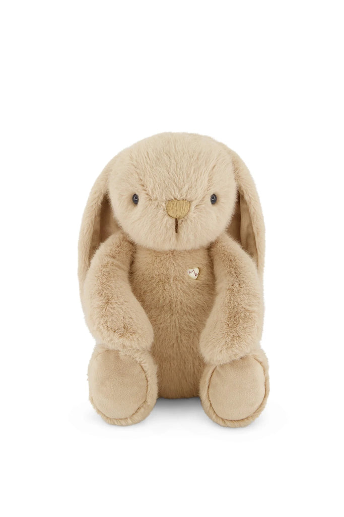Snuggle Bunnies - Penelope - Caramel is a soft, light brown plush bunny with floppy ears and a small gold heart on its chest, sitting upright—perfect for hugs and snuggles.