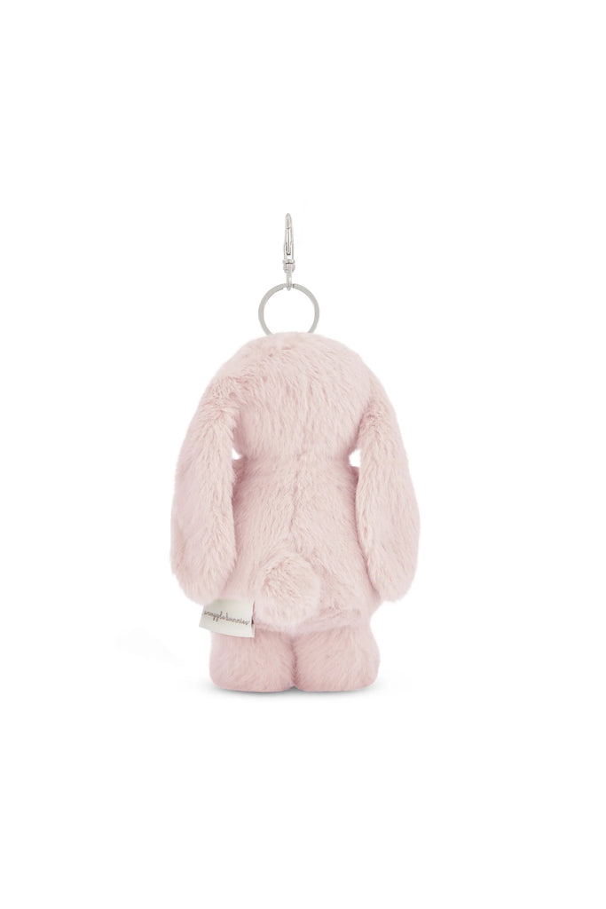 The Snuggle Bunnies - Penelope Keyring - Blossom is a soft, light pink plush bunny keyring with long floppy ears, a round tail, and a small fabric tag, shown from the back against a white background.