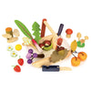 The Wild Wood Foraging Trug playset features a basket of toy fruits and vegetables, including cherries and mushrooms, along with a wooden knife. Create imaginative dishes using foraged plants around the basket with the included recipe leaflet.