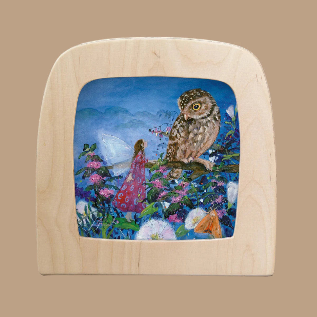 The product, "Silhouette Only - Little Fairy Can't Sleep Silhouette - Owl for Toverlux Lamp," depicts a fairy in a red dress among flowers facing an owl on a branch, framed in a wooden square with rounded corners on a solid tan backdrop.