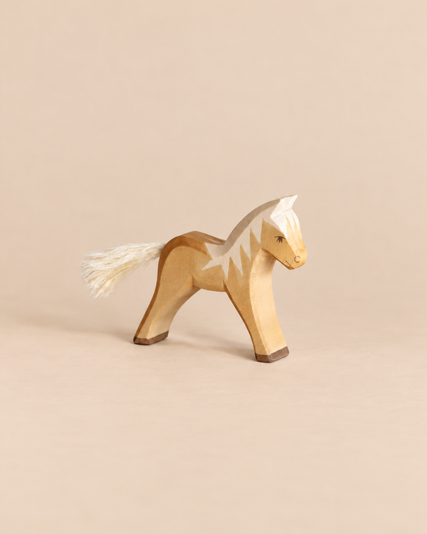 Ostheimer Horse - Haflinger Colt, a handcrafted wooden toy with a painted light brown body, white mane, and a white fiber tail.