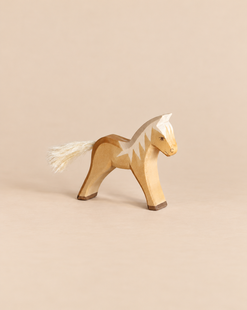 Ostheimer Horse - Haflinger Colt, a handcrafted wooden toy with a painted light brown body, white mane, and a white fiber tail.