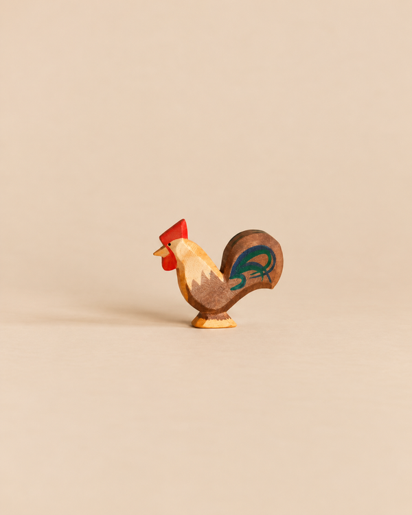 An Ostheimer Rooster - Brown handcrafted wooden figurine with a red comb and a dark-toned tail, perfect for imaginative play.