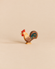 An Ostheimer Rooster - Brown handcrafted wooden figurine with a red comb and a dark-toned tail, perfect for imaginative play.