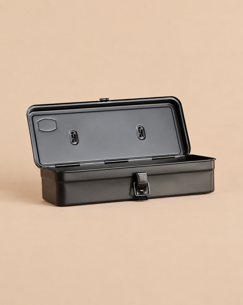 Multi Purpose Steel Storage Box T-320 - Black open toolbox with a front latch on a solid tan background.