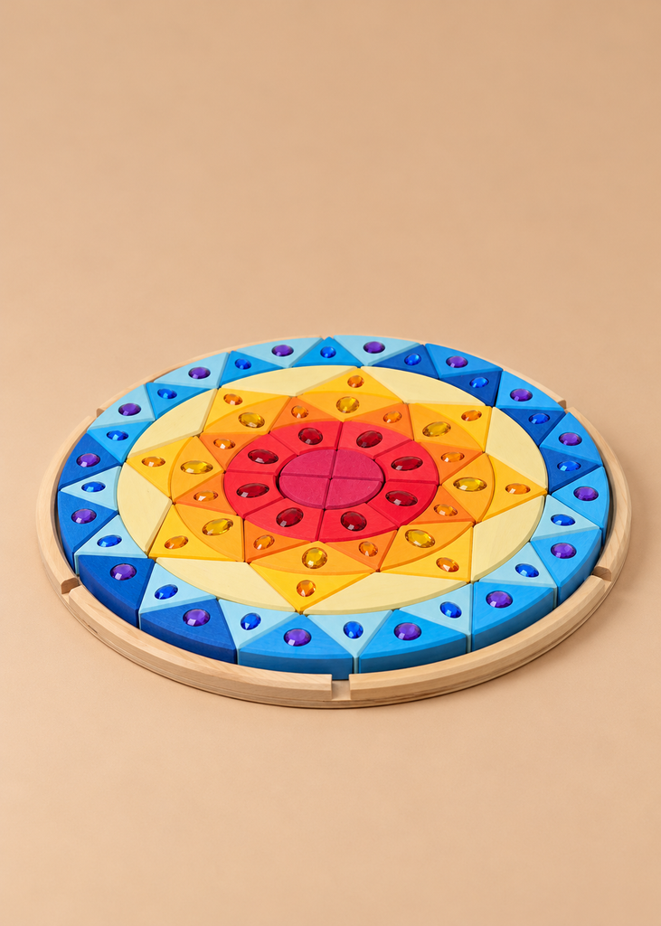The Grimm’s Sparkling Mandala Sun Creative Puzzle is a circular wooden puzzle with a sunburst pattern of colorful triangular blocks, each featuring a faceted jewel accent, designed to support fine motor skills.