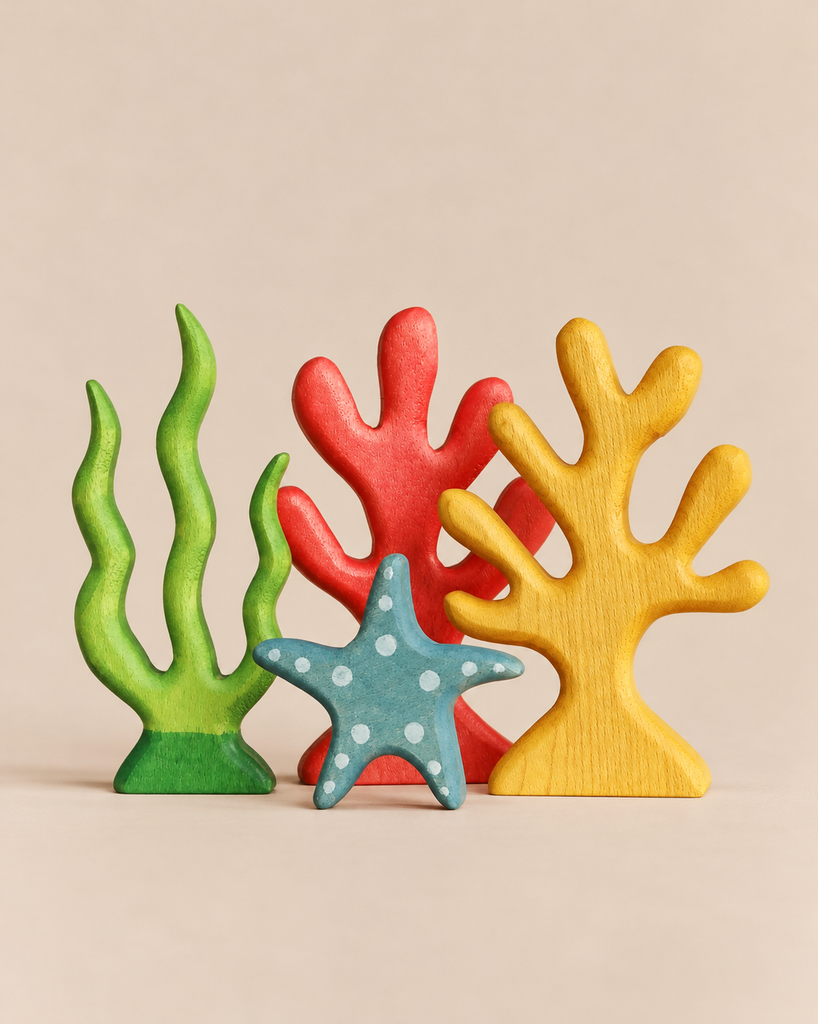 Handmade Holzwald Coral Reef set including a green seaweed shape, a red coral shape, a yellow branching coral shape, and a blue dotted starfish.