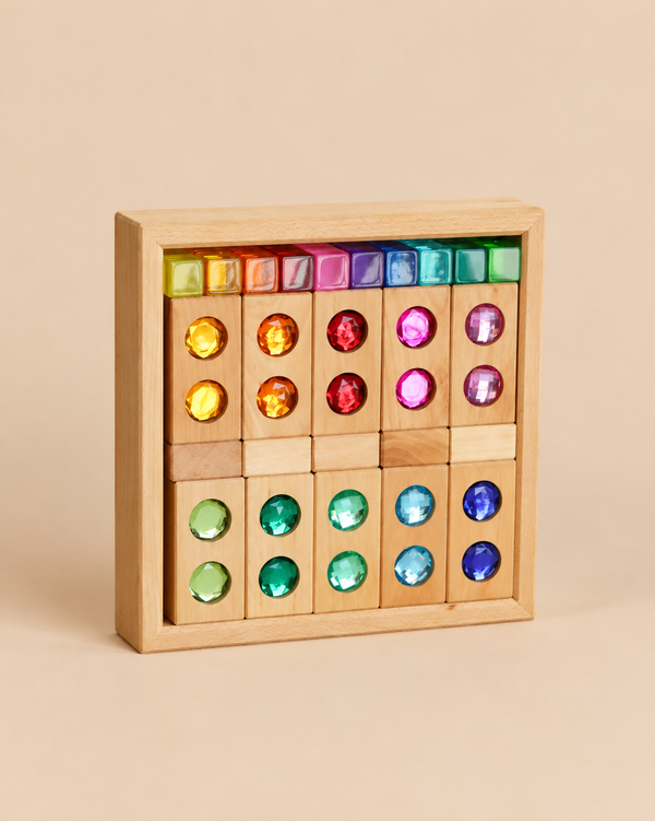 A wooden storage tray filled with a Bauspiel Gem Blocks with Lucent Cubes, 45-Piece Set, featuring construction blocks inlaid with colorful, faceted gemstones and topped by a row of small, translucent cubes.
