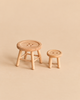 Two light-colored wooden Maileg Table & Stool, Mouse Size, with button-shaped seats, one larger than the other, serving as a charming mouse table and chair set.
