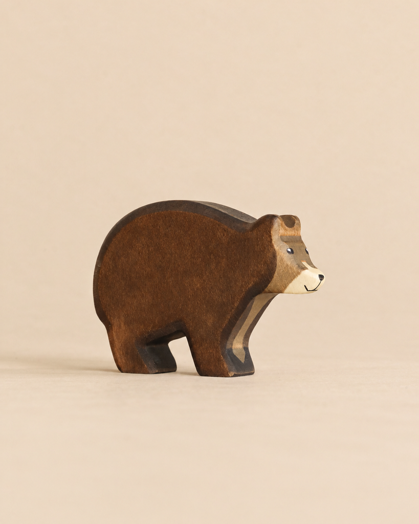 Handmade Holzwald Bear: a small, sustainable wooden toy bear in shades of brown with a light-colored face.