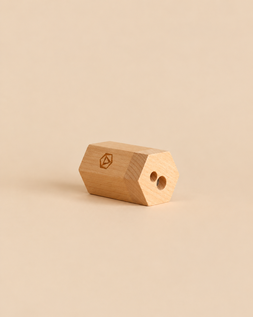 Hexagonal Stockmar Dual Pencil Sharpener with two holes, steel blades, and a small logo on the side.