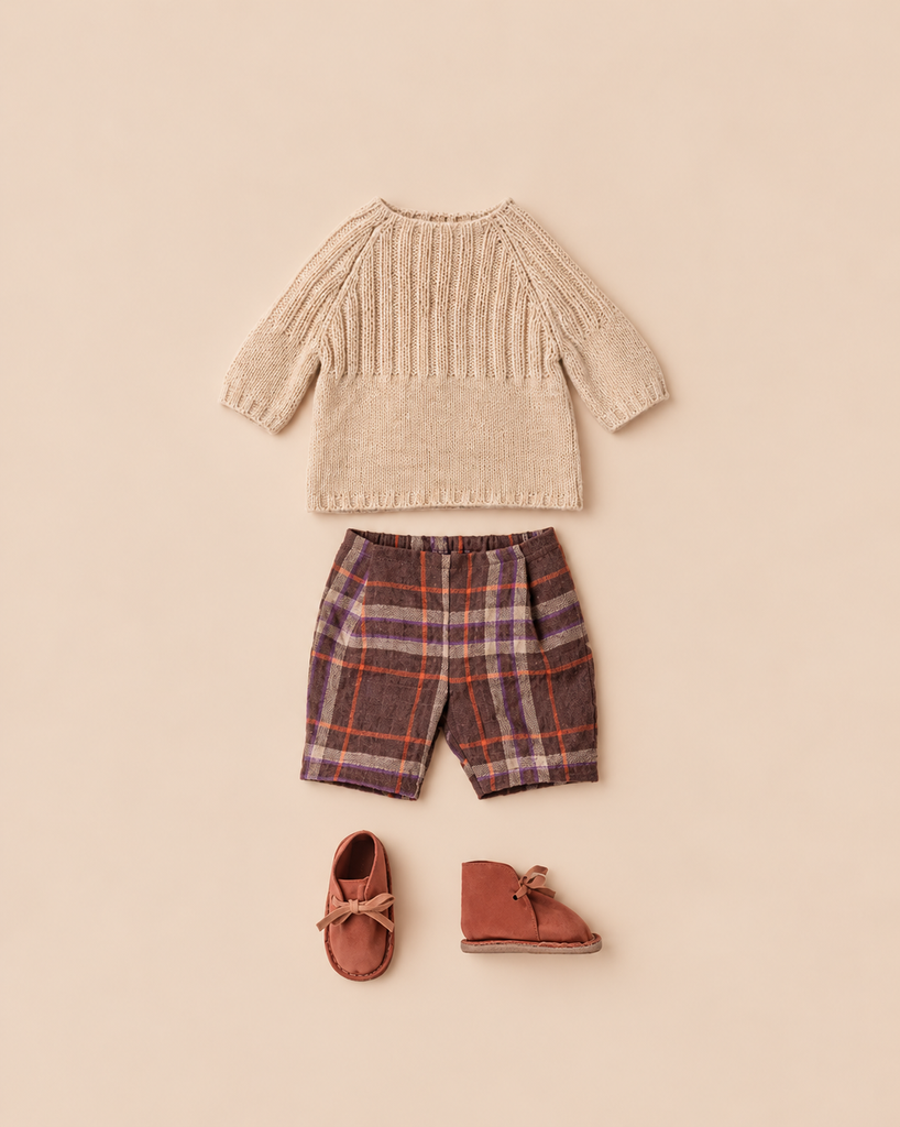 Maileg Pants and Knitted Sweater, Size 4 - Off White, consisting of a beige knitted sweater, brown and orange plaid shorts, and soft brown leather shoes with bows.