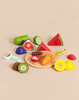 A Wooden Chopping Board & Sliceable Play Food set with a toy knife, surrounded by various pieces of sliced wooden play food.
