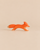 Ostheimer Fox - Running: a handcrafted wooden toy fox in a running pose with an orange body and white-tipped tail.
