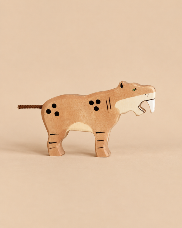Holztiger Saber-Toothed Tiger handcrafted wooden toy with painted spots, stripes, and prominent white fangs.