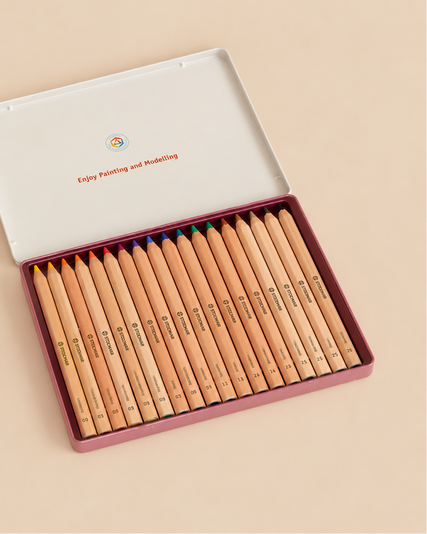 A Stockmar Hexagonal Colored Pencil Set - 18 Colors + Graphite Pencil arranged in an open metal tin.