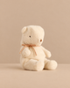 Maileg Teddy Bear Plush, Small - Off White sitting upright with a thin ribbon tied around its neck.