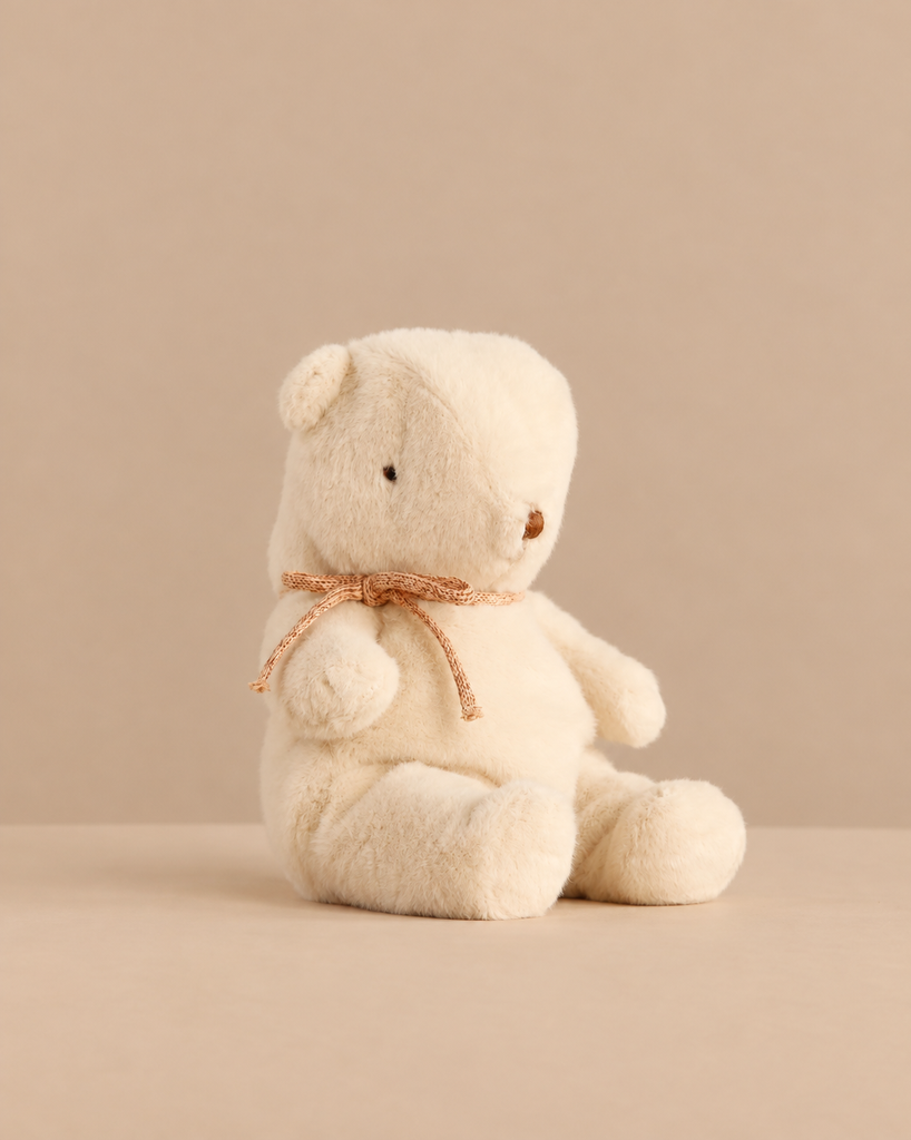 Maileg Teddy Bear Plush, Small - Off White sitting upright with a thin ribbon tied around its neck.