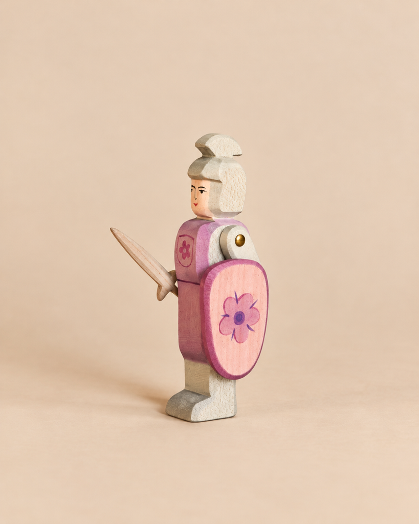 Handcrafted wooden Ostheimer Red Knight - Standing in pink armor holding a sword and a shield with a flower motif for imaginative play.
