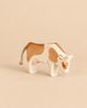 Handcrafted Ostheimer Cow - Eating, a wooden toy with brown patches, head bowed as if grazing, and a braided rope tail.