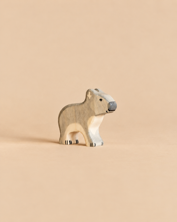 A Holztiger Koala, Standing handcrafted wooden toy koala shown in profile.