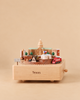 A Texas Wooden Music Box featuring a rotating platform with miniature models of the Texas State Capitol, the Alamo, an oil derrick, a rocket, and a red truck, complete with a sign reading “Don’t Mess With Texas.”