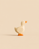 Small handmade wooden duck figurine from the Handmade Holzwald Woodland Animals Set with an orange beak and feet.