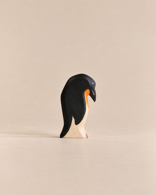 Handmade Holzwald Penguin, Head Down, a small wooden toy figurine crafted from sustainable materials shown with its head bowed downward.