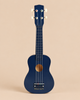 Konges Sloejd Wooden Ukulele - Midnight in dark blue FSC certified wood with four strings and a gold circular sound hole.