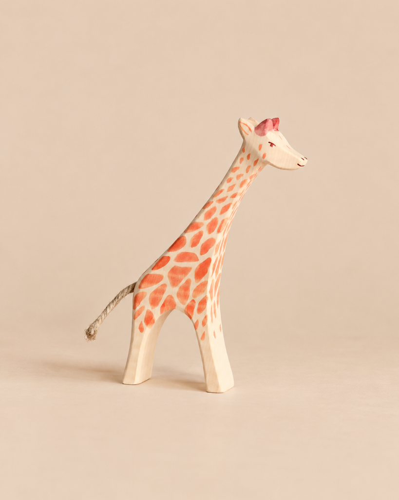 Hand-carved Ostheimer Giraffe - Running wooden figurine with orange spots, a rope tail, and the classic aesthetic of handcrafted wooden toys.