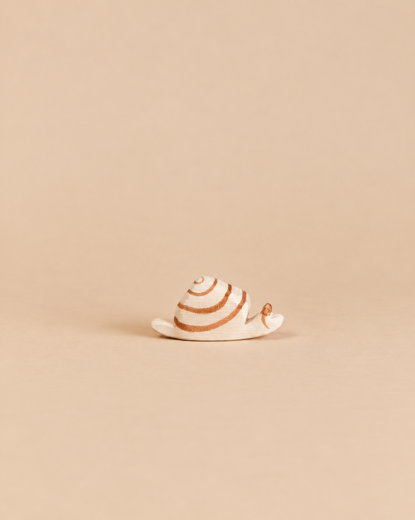 Ostheimer Snail handcrafted wooden figure featuring a small shell with painted brown spiral markings, perfect for imaginative play.