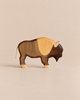 Handmade Holzwald Bison handcrafted wooden toy with two-toned brown wood and a simple string tail.