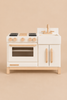 Milton & Goose Essential Play Kitchen in white wood with a stove, oven, sink, and natural wood accents for imaginative play.