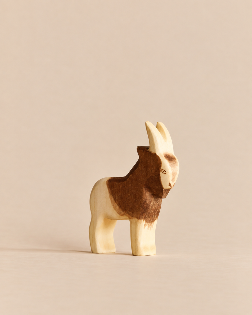 Hand-carved Handmade Holzwald Goat figurine featuring natural light and dark wood grain.