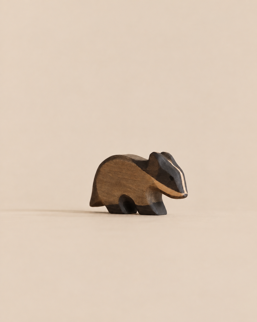 A Handmade Holzwald Badger, a carved wooden toy figurine of a badger.