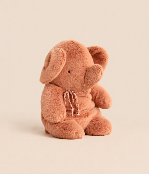 A soft Maileg Elephant Plush, Medium - Vintage Rose in a dusty rose color with a small decorative ribbon tied around its neck.