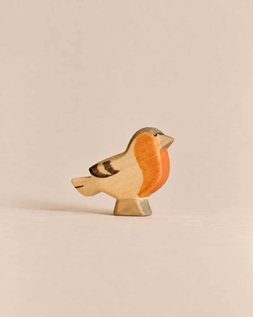 Handmade Holzwald Bird - Finch, a hand-carved wooden toy of a finch with an orange breast and brown wing details.